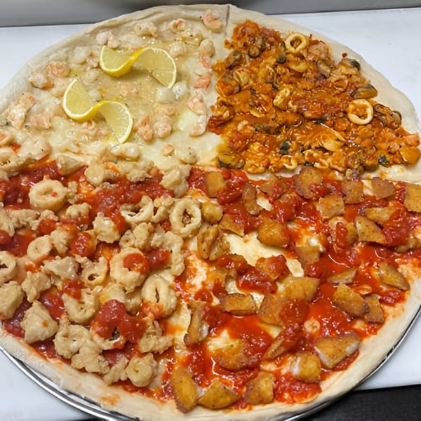 A large Brunello's Pizza with four distinct seafood toppings: shrimp scampi, mixed seafood, fried calamari, and fried fish.